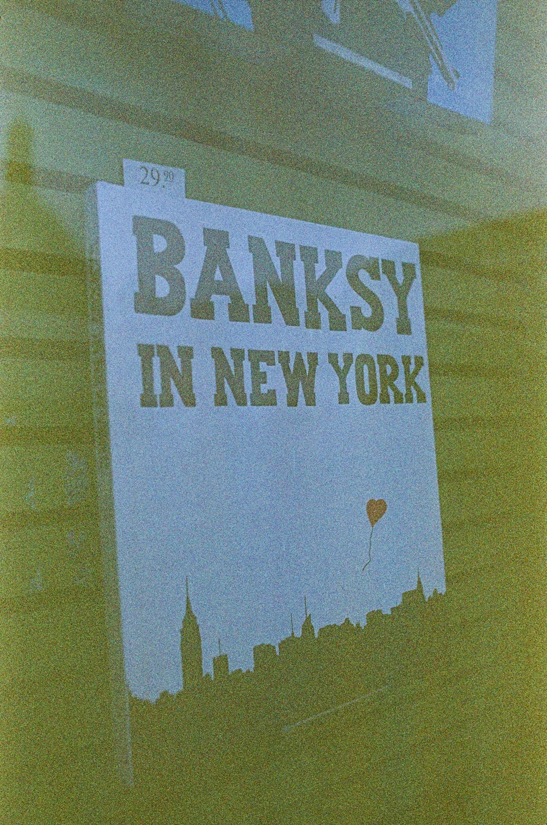 a sign on the side of a building that says banksy in new york
