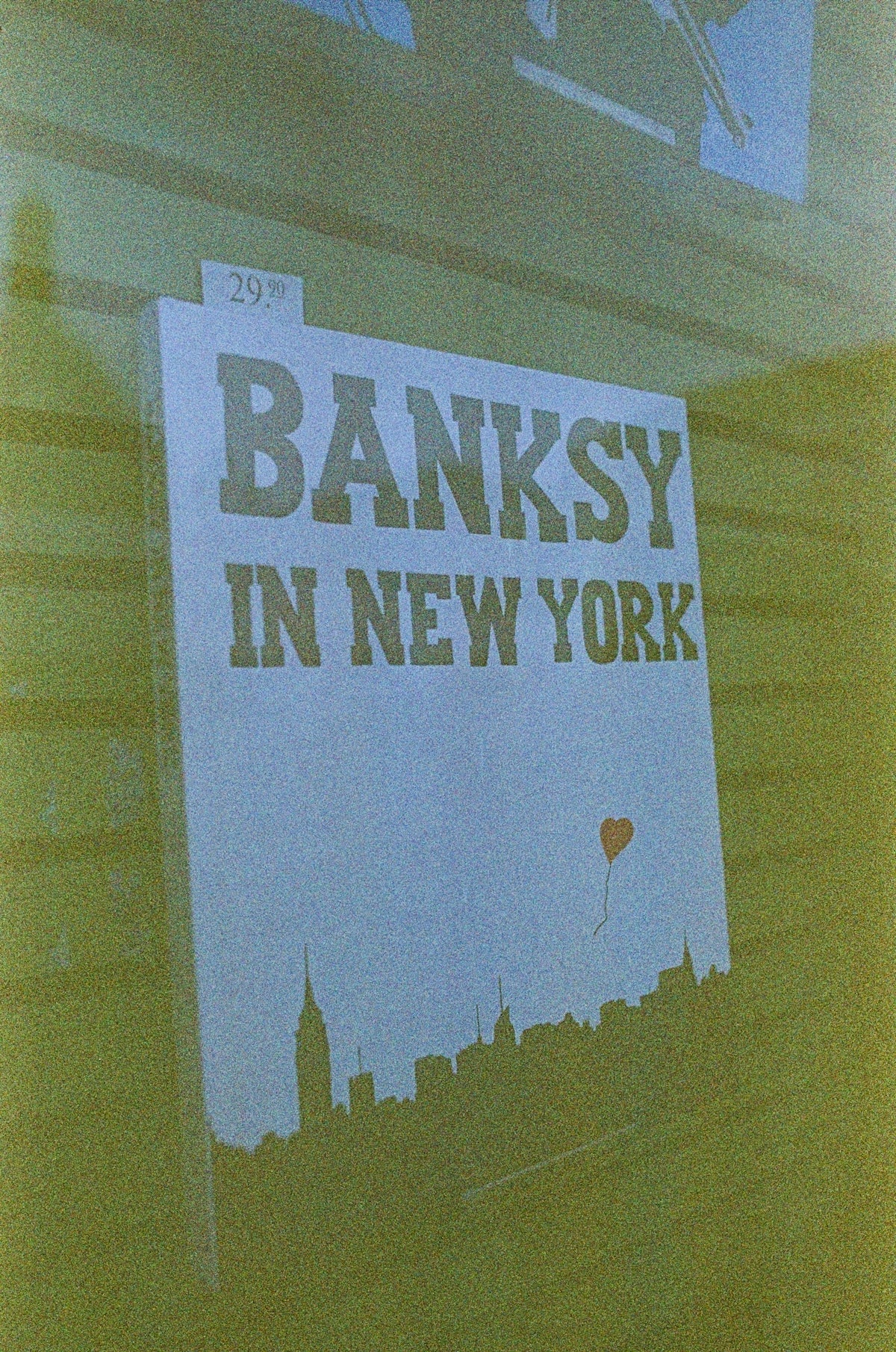a sign on the side of a building that says banksy in new york