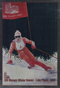 Official 1980 Lake Placid XIII Winter Olympics foil poster featuring Olympic symbols and vibrant design by an unknown artist.