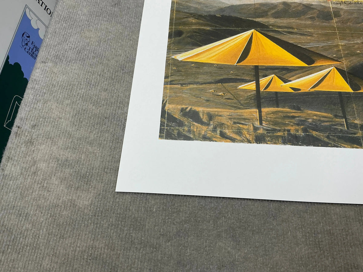 Offset lithograph poster of Christo & Jeanne-Claude's Yellow Umbrellas art exhibition, featuring vibrant yellow umbrellas.