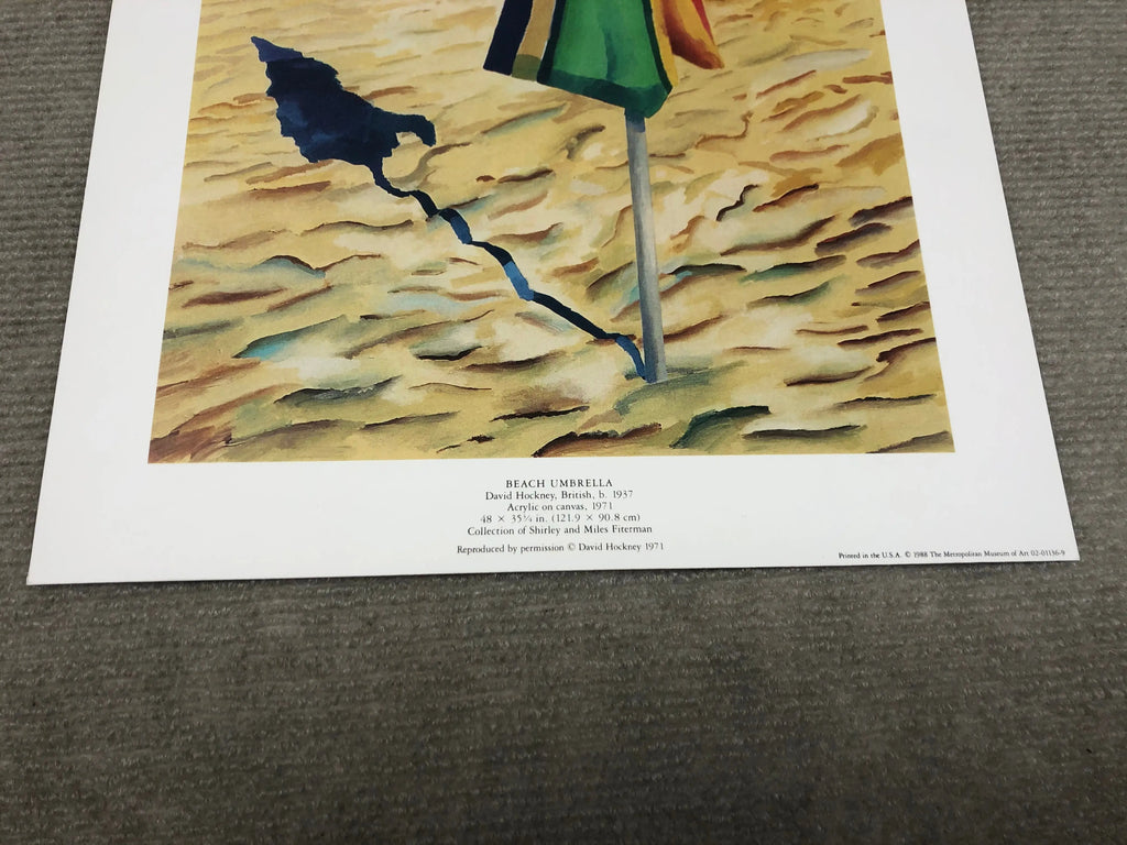 David Hockney beach umbrella print from 1988, featuring vibrant colors and abstract design, displayed in a Metropolitan Museum exhibit.