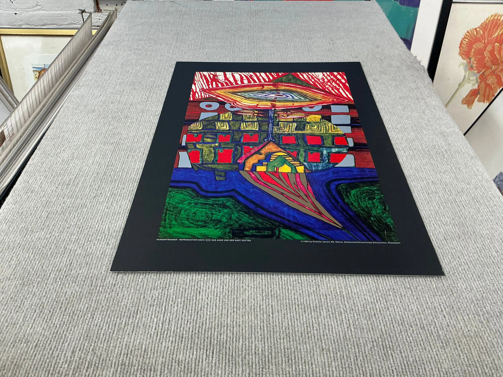 Friedensreich Hundertwasser art poster titled "The Eye and the Beard of God" featuring vibrant abstract design and colorful shapes.
