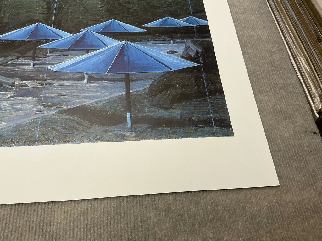 Javacheff Christo The Blue Umbrellas 1995 exhibition art poster showcasing vibrant blue umbrellas in an outdoor installation.
