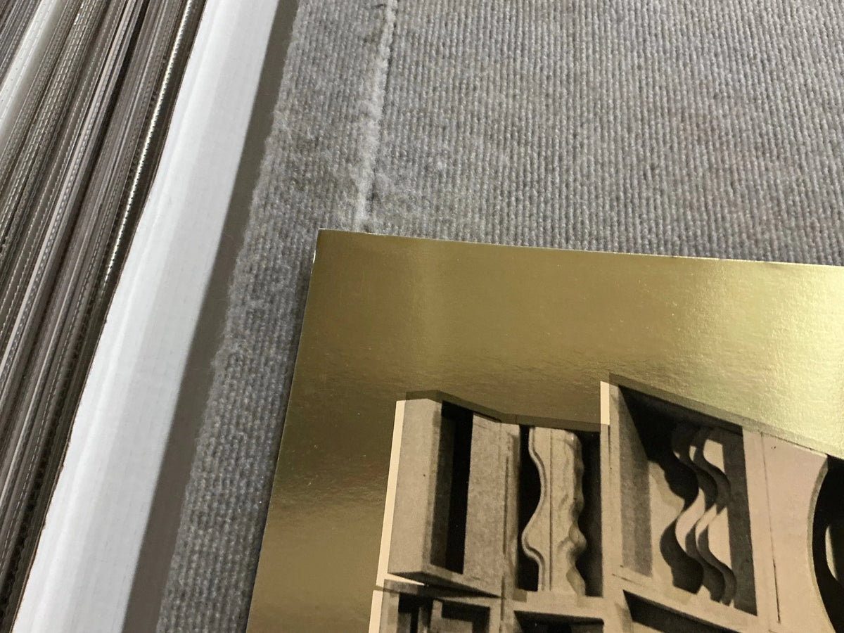 Louise Nevelson Gold Dust and Shadows 1977 foil print poster showcasing abstract art with metallic gold accents and shadow effects.