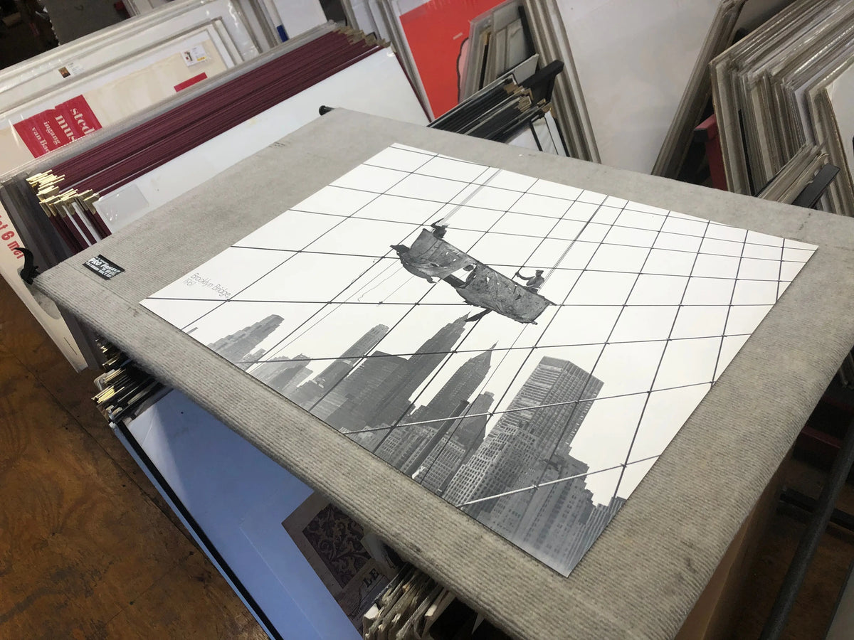 Otto Bettmann lithograph poster of workers on the Brooklyn Bridge from 1991, showcasing detailed vintage illustration art.