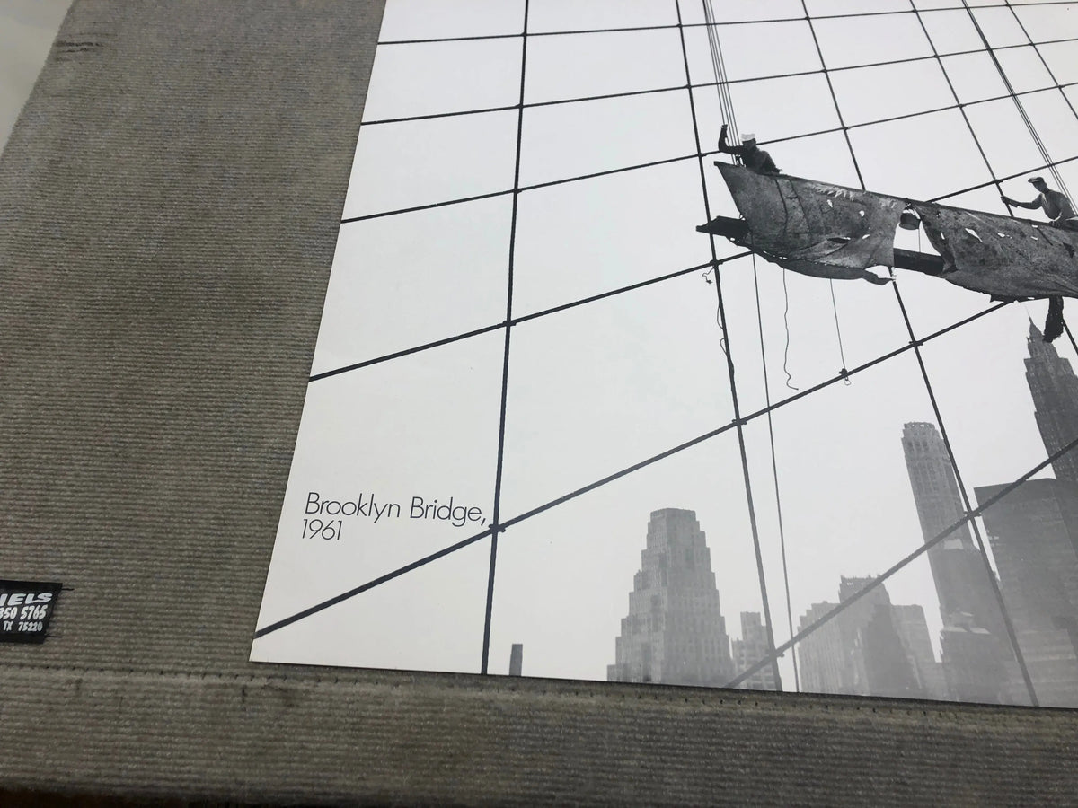 Otto Bettmann lithograph poster from 1991 showing workers on the Brooklyn Bridge, vintage black-and-white illustration.