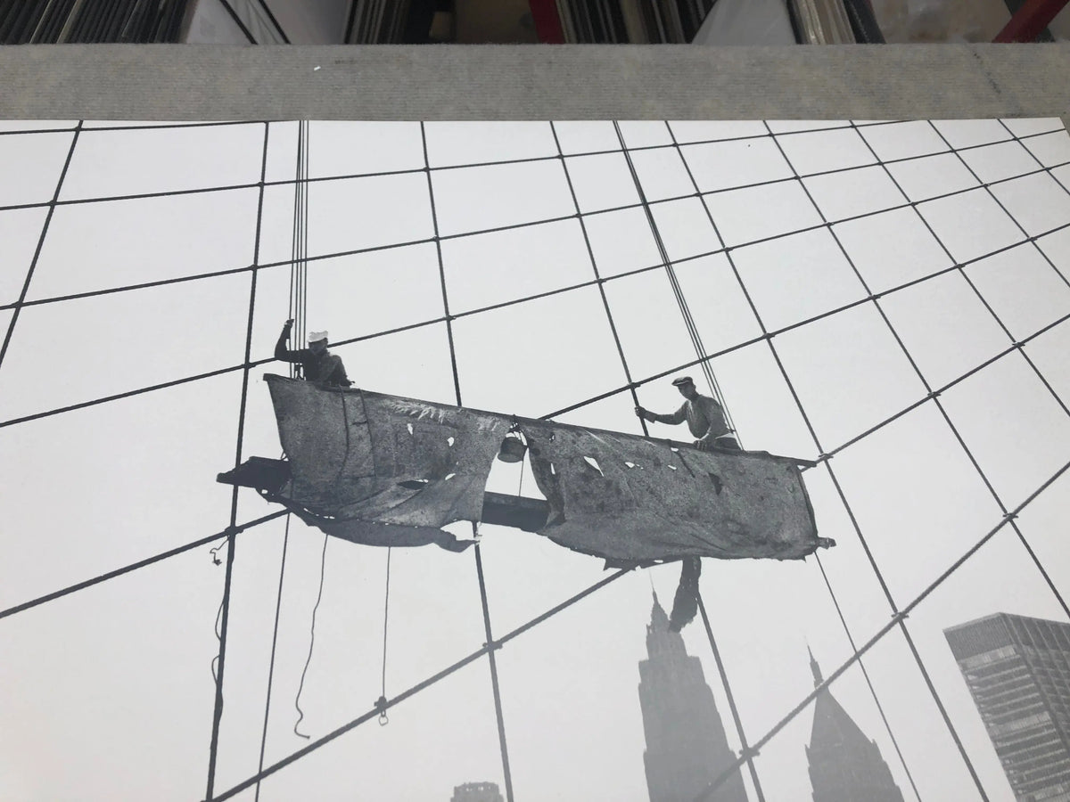 Otto Bettmann lithograph poster of workers on the Brooklyn Bridge in 1991, showcasing detailed historic imagery.
