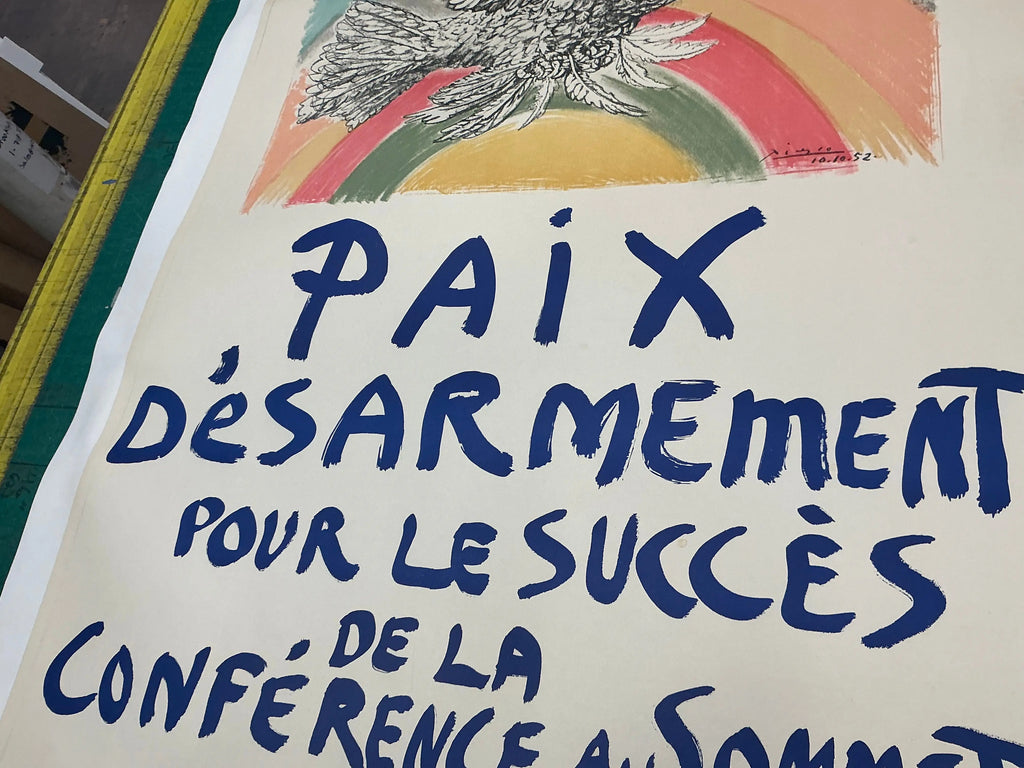 Original 1960 Pablo Picasso lithograph poster titled "Paix Disarmement Peace" from the exhibition, featuring abstract artwork in black and white.