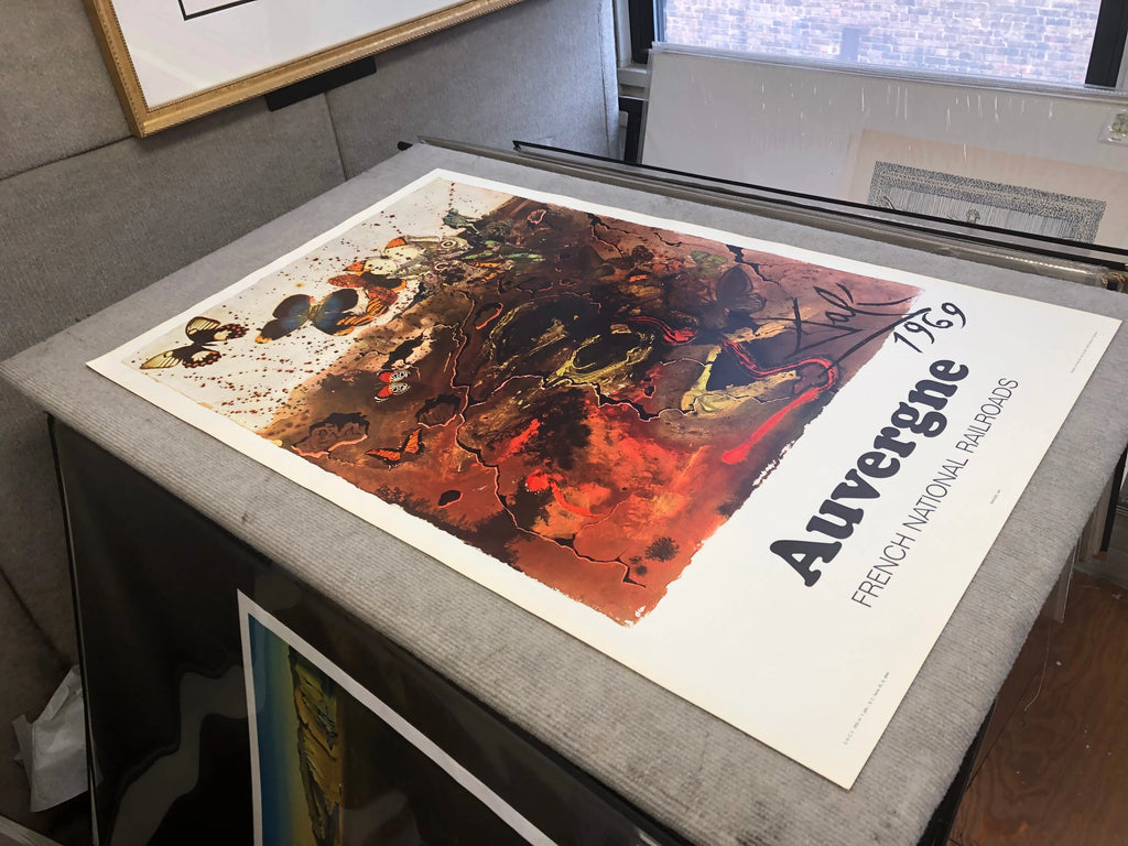 Vintage Salvador Dalí Auvergne 1970 French Railway lithograph poster featuring surreal artwork and railway imagery.