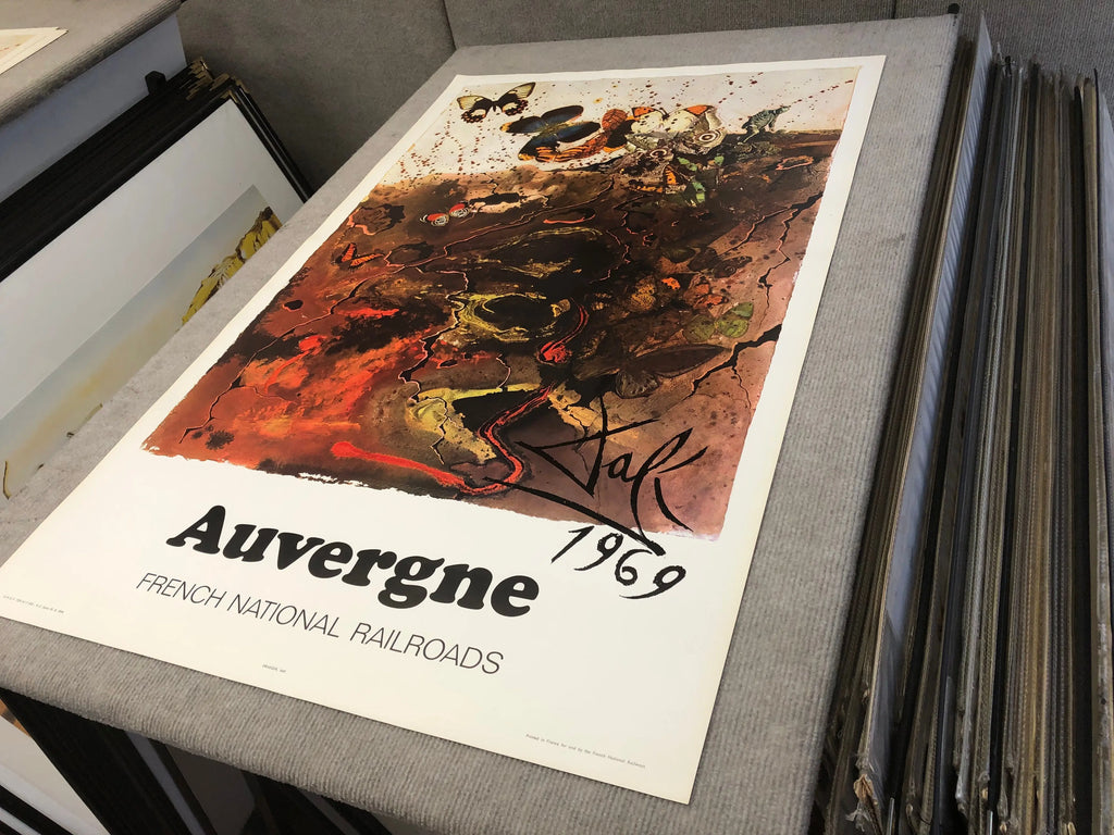 Vintage Salvador Dalí Auvergne 1970 French Railway lithograph poster with surreal artwork and vibrant colors.