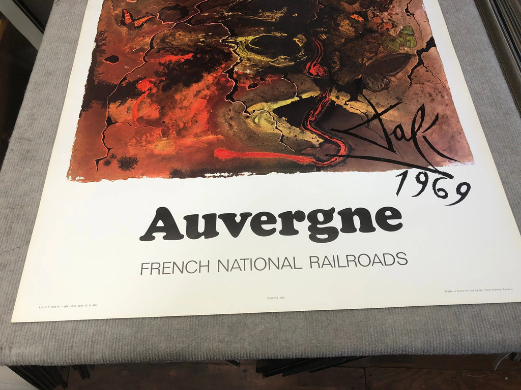 Vintage Salvador Dalí Auvergne 1970 French Railway SNCF lithograph poster, featuring surrealist artwork and vibrant colors.