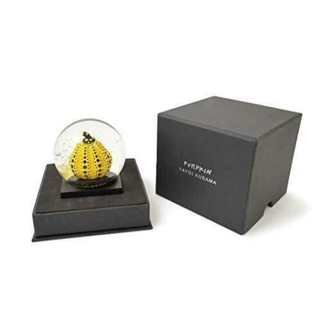 Limited edition Yayoi Kusama Snow Dome sculpture featuring a yellow pumpkin, showcasing vibrant colors and intricate details.